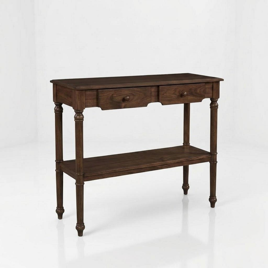 The Marcy Console Table, handcrafted from solid wood by skilled American craftsmen, features a dark finish, two drawers, a lower shelf, and turned legs. It is topped with a durable protective coat and is set against a plain white background.