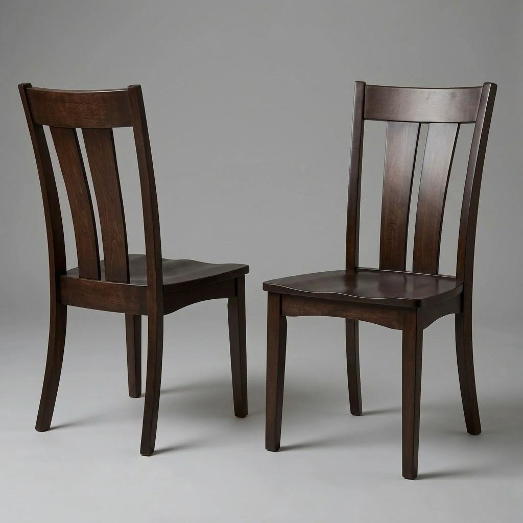 Two Navien Chairs, crafted from solid hardwood in a dark finish, are positioned on a plain gray background; one chair faces forward while the other is turned to the side, showcasing both the front and side profiles of this durable wooden furniture.