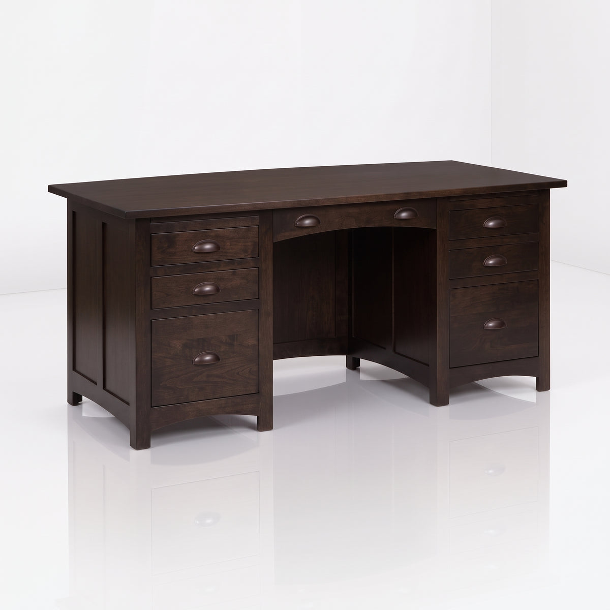 The Owen Hardwood Desk is a handcrafted dark brown solid hardwood executive desk with five drawers and a center drawer, featuring bronze-toned half-moon pulls.