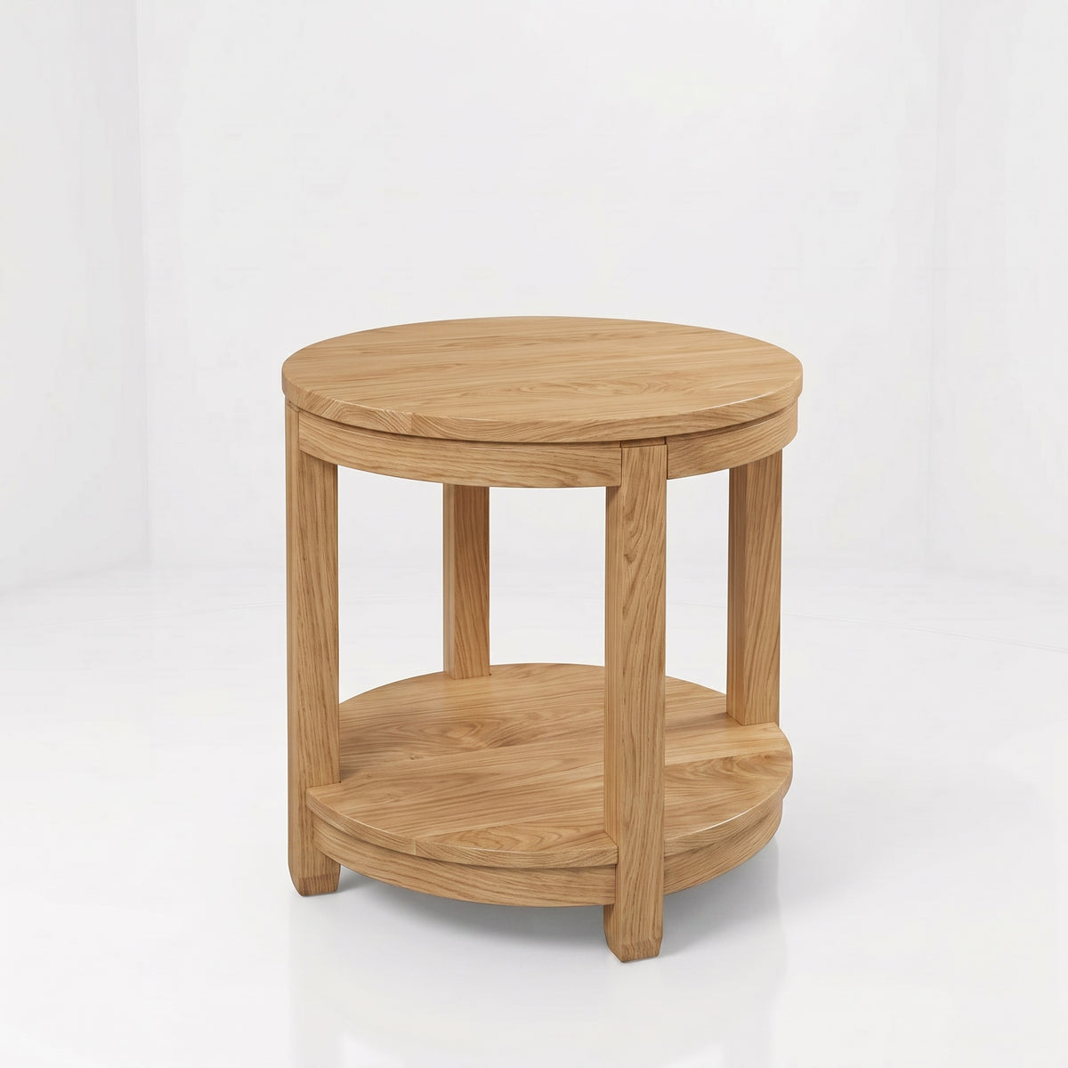 The Adams Round End Table, expertly handcrafted from solid wood by American craftsmen, features four legs and a lower circular shelf. Showcasing a simple, natural wood finish with visible grain patterns and a durable top coat for lasting beauty, this round side table is set against a plain white background.