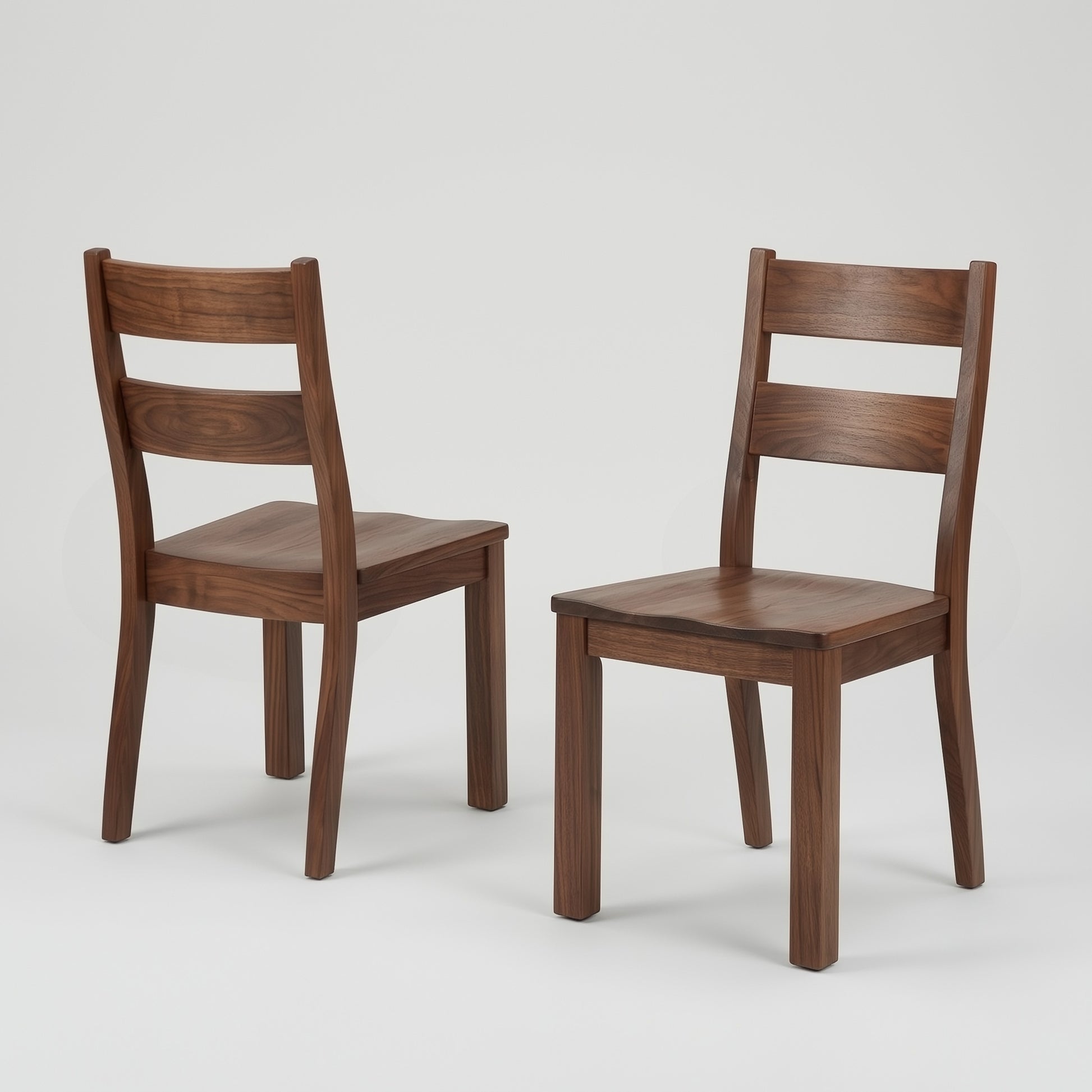 Two solid walnut handcrafted usa made custom wooden chairs on a light gray background