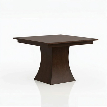 The Ambrose Dining Table, handcrafted from solid wood by skilled American craftsmen, features a modern, minimalist design with a dark wood square top and a wide, flared pedestal base. Shown on a white background.