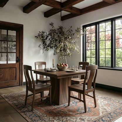 Our walnut ambrose square expandable leaf table in a Dining room with wooden table and chairs, large window, and decorative rug.