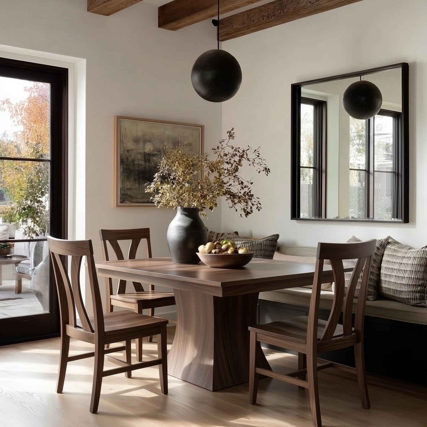 Dining room with solid hardwood handcrafted walnut usa made custom wooden table and chairs, vase with flowers, and large mirror on the wall.