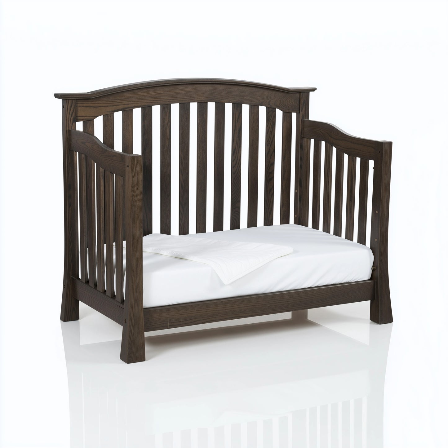 The Archer crib converted into a toddler bed, on white. 