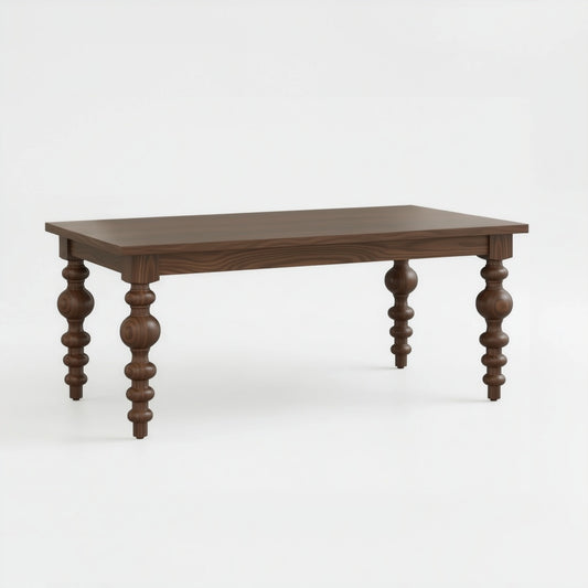 The Aubrey Dining Table is a rectangular solid walnut piece with a smooth top and four intricately carved spindle-style legs, handcrafted in the USA, shown against a plain white background.