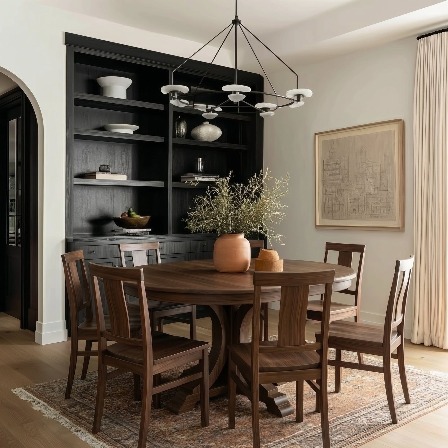 Dining room with wooden walnut handcrafted usa made craftsman solid table and chairs, black shelving unit, and framed artwork on the wall.