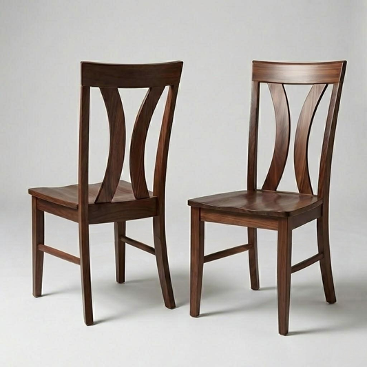 Two wooden chairs with a curved back design on a light gray background. Handcrafted in the USA from solid walnut.