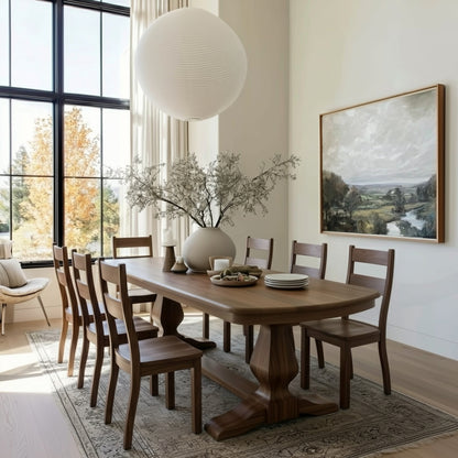 handcrafted usa made custom solid hardwood walnut double pedestal dining table and chairs, organic modern white dining room with large black windows and landscape oil painting.