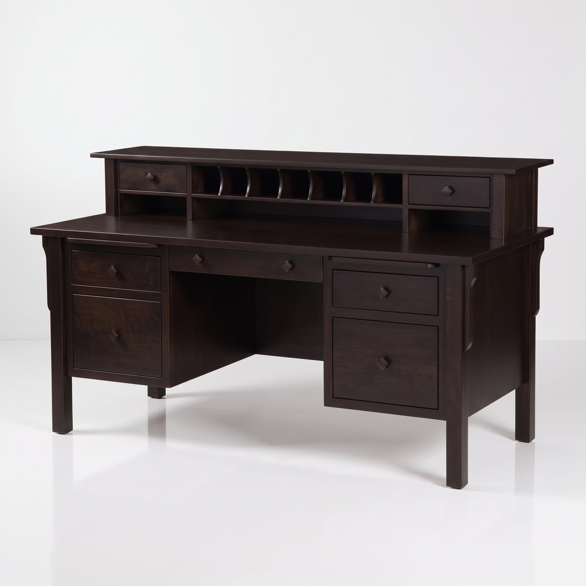 A dark brown wooden writing desk with a hutch, featuring multiple drawers, open shelving, and a central open space, shown on a white studio background.