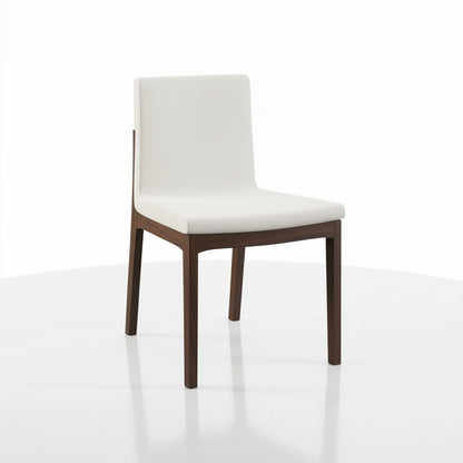 The Carver Chair features a white cushioned seat and backrest with sleek dark wooden legs, displayed on a white surface against a plain white background.