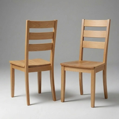 Two Dalton Chairs, handcrafted in the USA from solid hardwood with ladder-style backs, are positioned on a plain gray background—one facing forward and the other turned to showcase the back. These chairs feature a simple, modern design complemented by a durable finish.