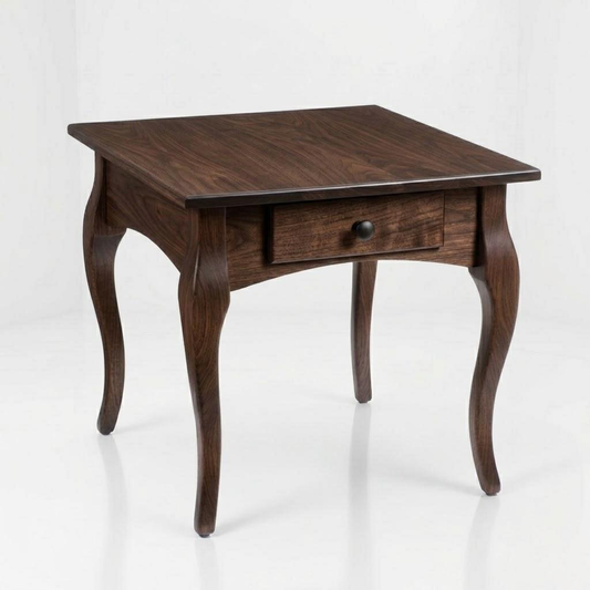 Handcrafted from solid wood by skilled American craftsmen, The Fox End Table showcases elegantly curved legs and a single drawer with a round knob, presented against a plain white background.