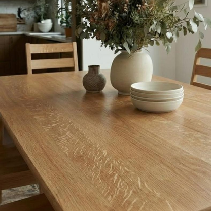Wooden dining table with decorative items in a home setting