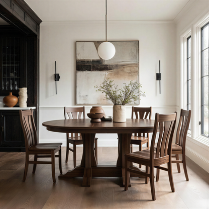 handcrafted custom walnut semi-oval dining table and walnut usa made chairs in a ding room with window, modern art, natural rug. Organic modern feel, moody dark kitchen cabinets
