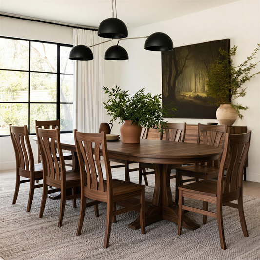 handcrafted custom walnut oval dining table and walnut usa made chairs in a city living room with big black frame window, modern art, natural rug. Organic modern feel, black light fixture