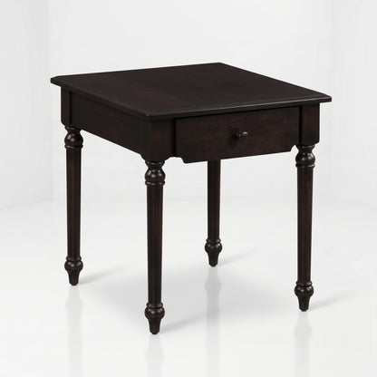 The Marcy End Table, handcrafted from solid wood by skilled American craftsmen, is a dark wooden square side table featuring four turned legs and a single drawer with a round knob, set against a plain white background.