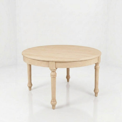 The Marcy Round Coffee Table, handcrafted in the USA from light wood with four turned legs, is showcased against a white, minimal background.