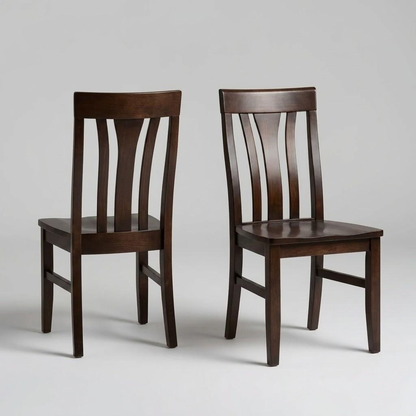 Two Marigold Chairs, handcrafted in the USA from solid hardwood and featuring dark wooden frames with slatted backs and square seats, are positioned side by side—one facing forward and the other angled slightly—against a plain light gray background.