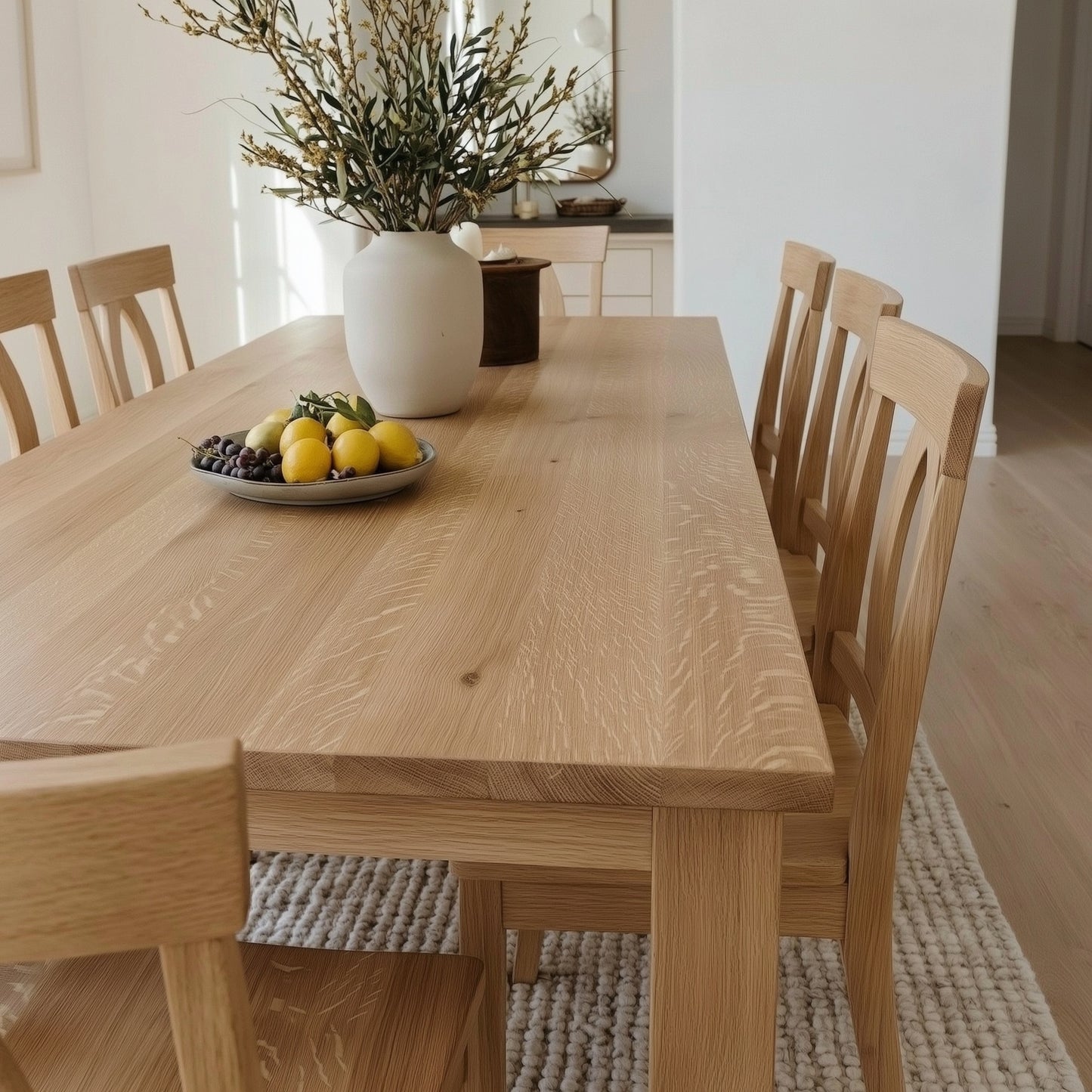 Wooden dining table with chairs in a bright room