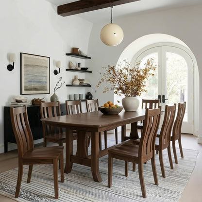 Dining room with wooden table and chairs, decorative elements, and a large window. Solid walnut usa handcrafted custom durable finish.