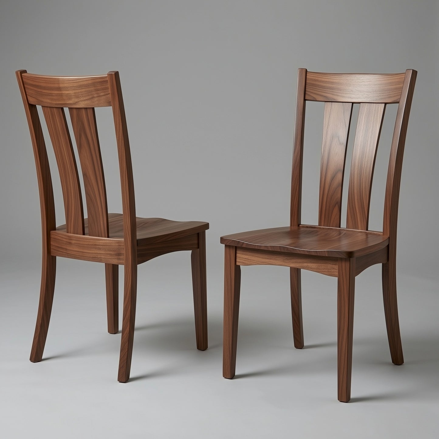 Two wooden solid walnut usa made custom chairs on a gray background