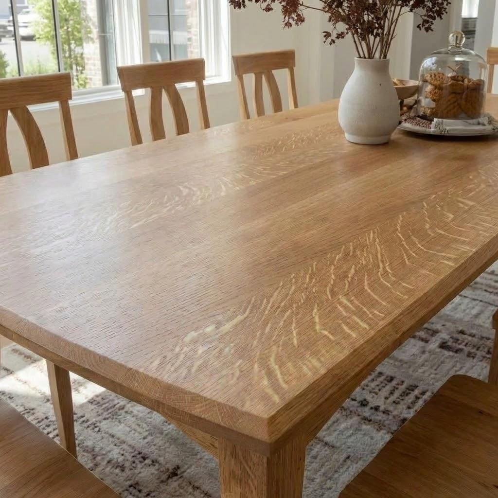 Wooden dining table with chairs in a bright room