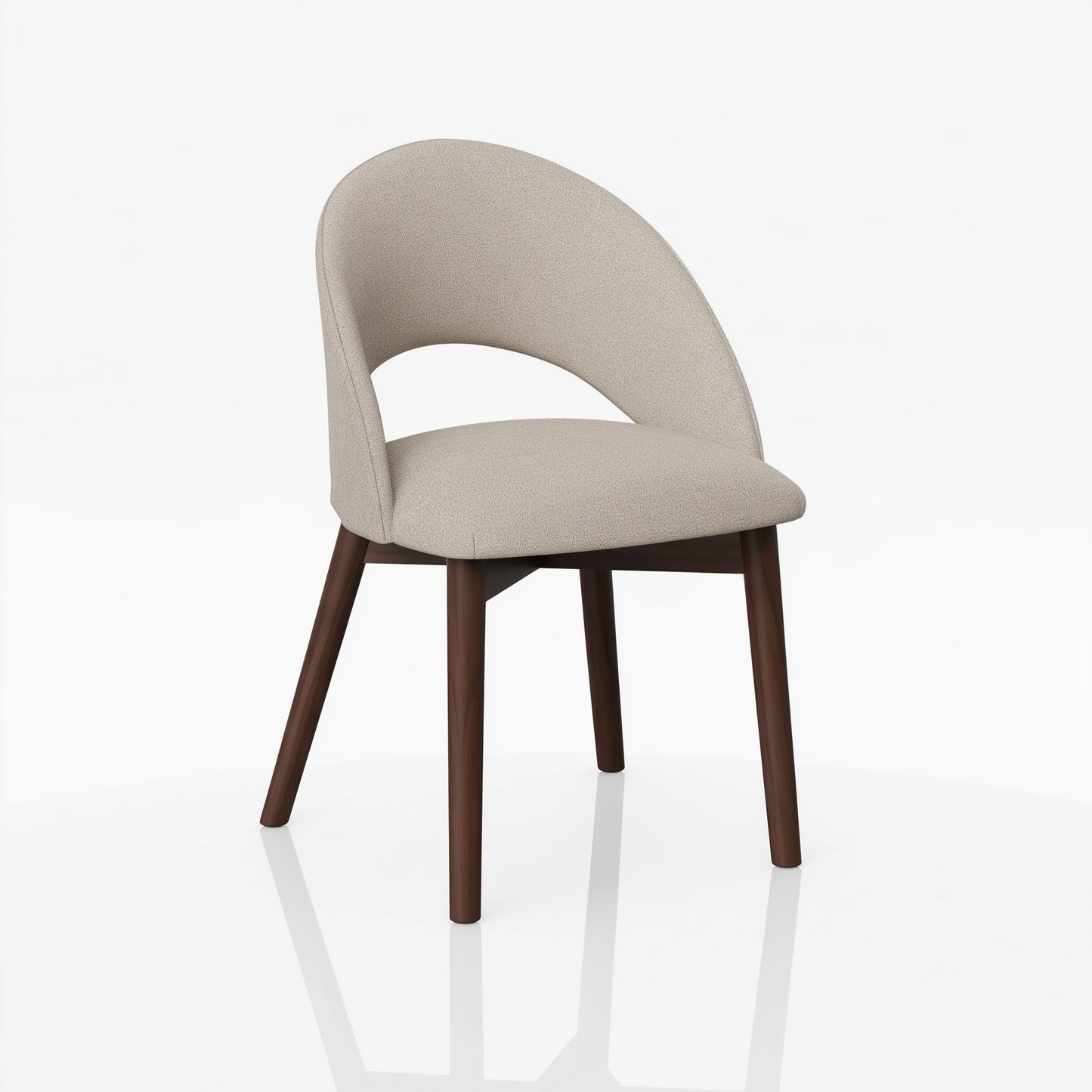 The Oakes Chair is a modern hardwood chair with a curved, light beige upholstered back and seat featuring a lower back cutout. Handcrafted, it stands on four angled dark wood legs and is displayed against a plain white background.