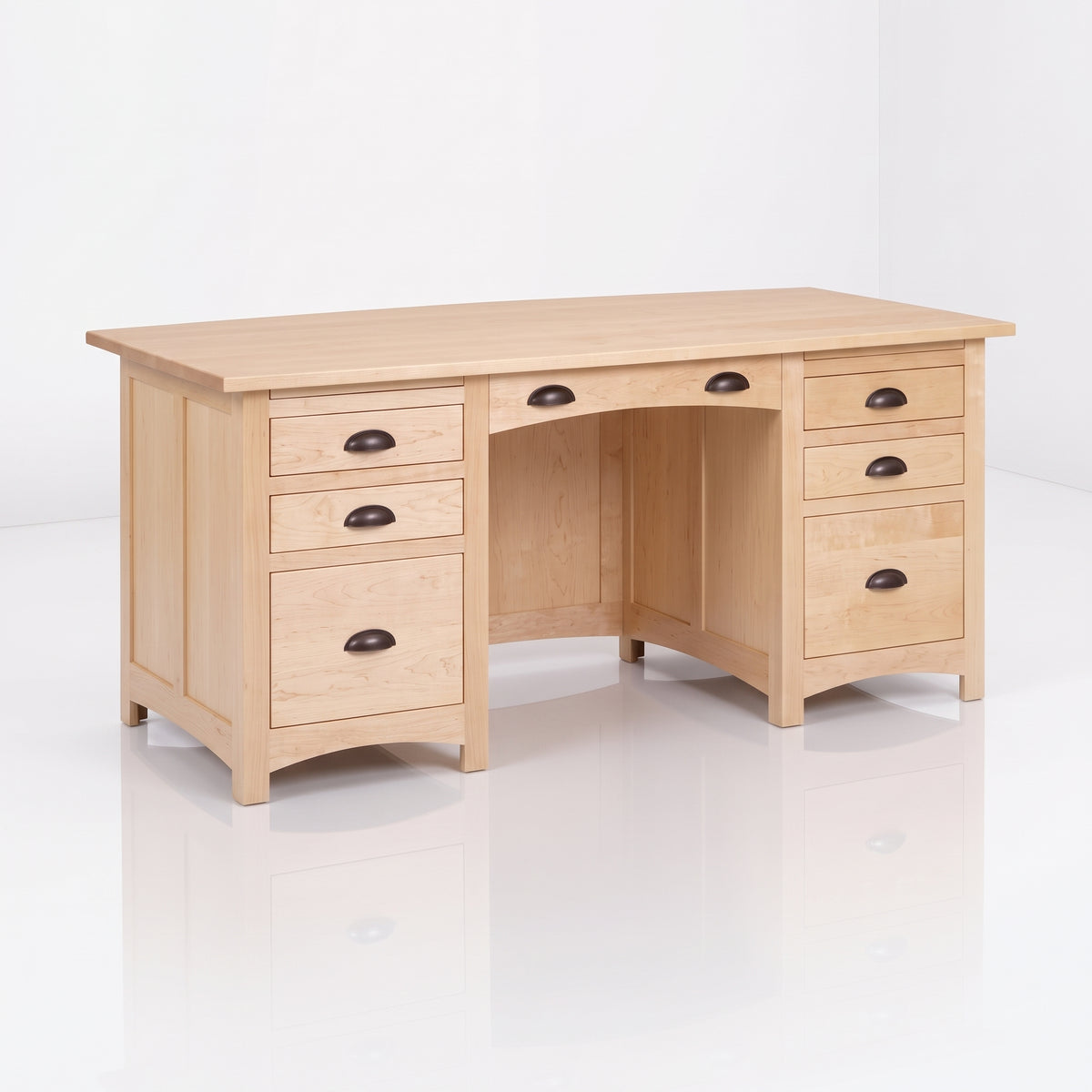 The Owen Hardwood Desk is a handcrafted solid hardwood executive desk with a light-toned rectangular top and seven drawers featuring dark metal cup pulls.