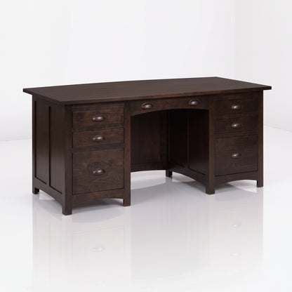 The Owen Hardwood Desk is a handcrafted dark brown solid hardwood executive desk with five drawers and a center drawer, featuring bronze-toned half-moon pulls.