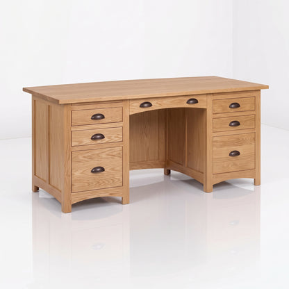 The Owen Hardwood Desk is a handcrafted wooden pedestal desk featuring two columns of drawers, a central drawer, and dark metal cup pulls.