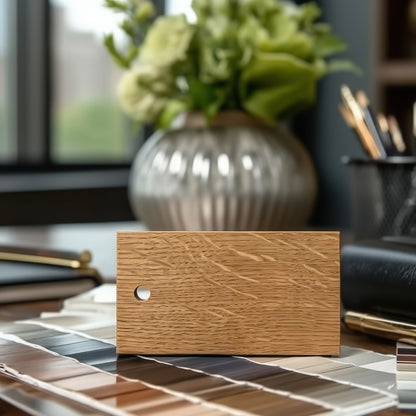 A natural quarter-sawn white oak wood swatch sample on an interior designers desk