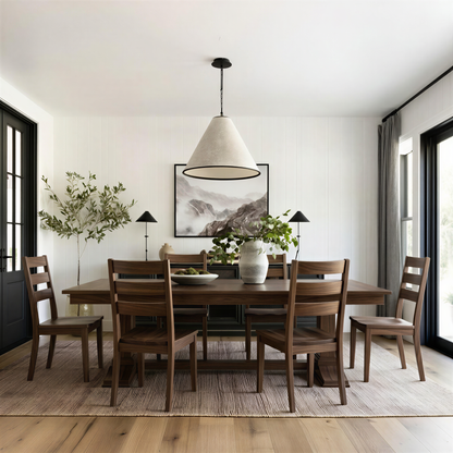 Dining room with wooden table and chairs, modern pendant light, and framed artwork on the wall. Solid handcrafted walnut table and chairs. USA made. extendable.