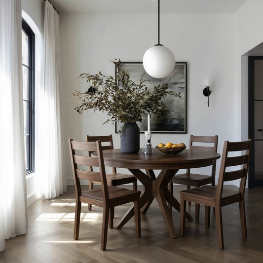 Dining room with wooden walnut handcrafted usa made table and chairs, vase with flowers, and framed artwork on the wall. white curtains, modern moody artwork, white glass round lighting.