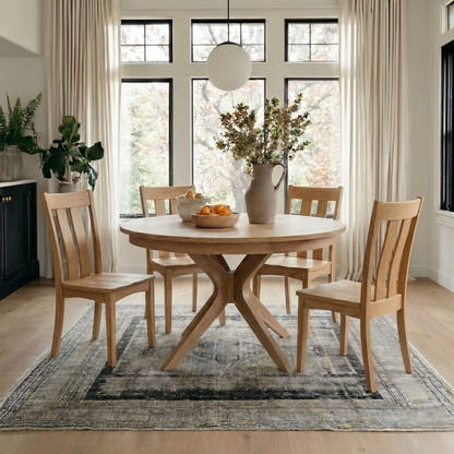 Dining room with wooden table and chairs in a well-lit room.